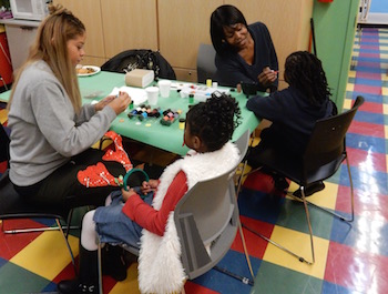 two-girls-receive-facepaint-at-Christmas-Toy-Giveaway