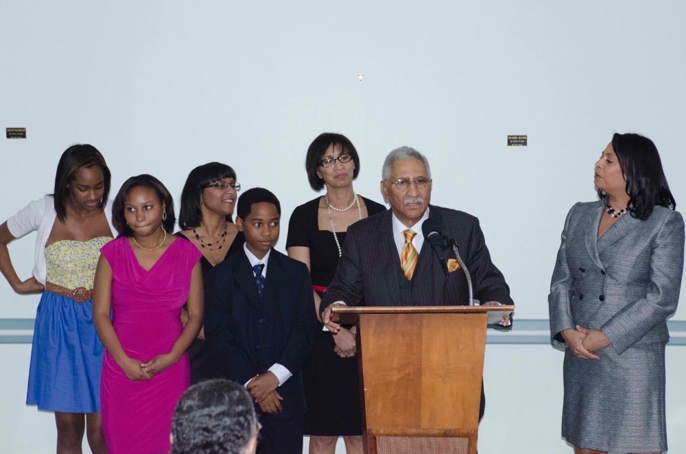 man-at-podium-with-group-community-luncheon